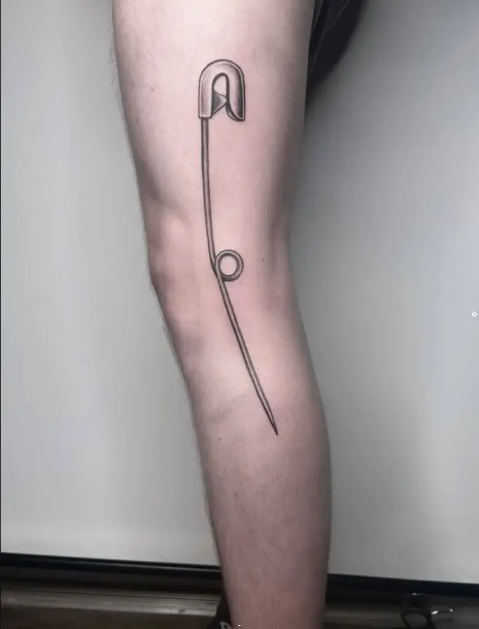 Fine line safety pin tattoo by Eric Axle Nashville