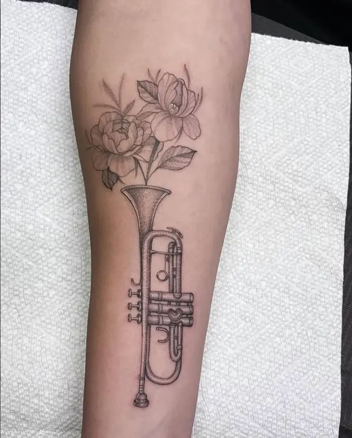 Fine line trumpet and flowers tattoo by Eric Axle Nashville