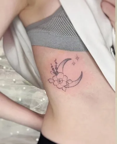 Crescent moon and flowers fine line tattoo by Natasha Rachel