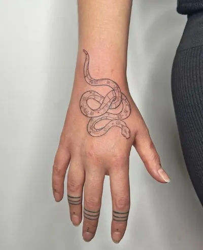 Snake fine line hand tattoo by Natasha Rachel
